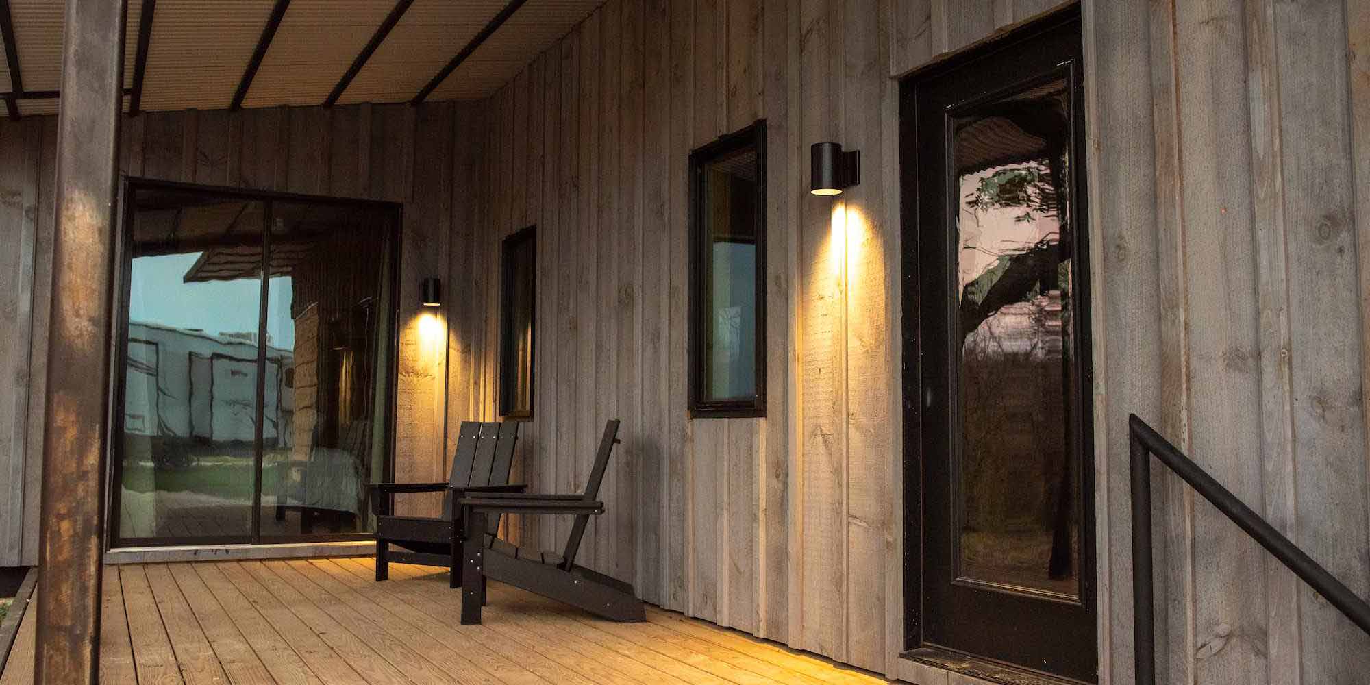 The relaxing front porch of a Mammoth Cabin at Camp Fimfo Waco