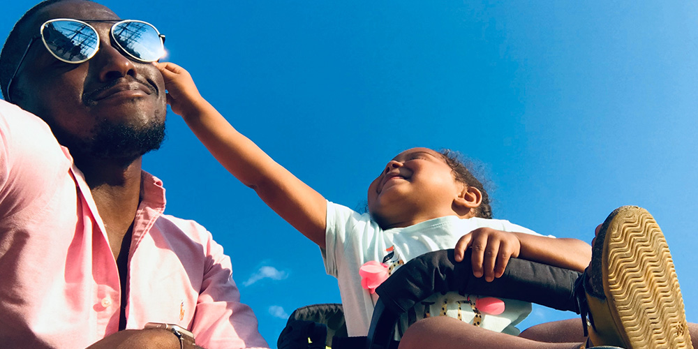 Girl reaching for dad's sunglasses during Dad Fest - a great event near Albany, NY!