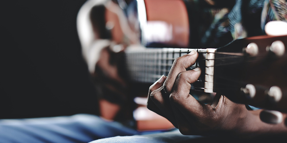 Man playing guitar at a country concert.