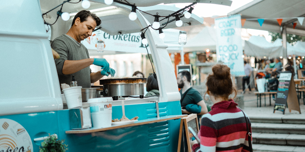 Woman buying food from a local food truck at a Charlotte event.