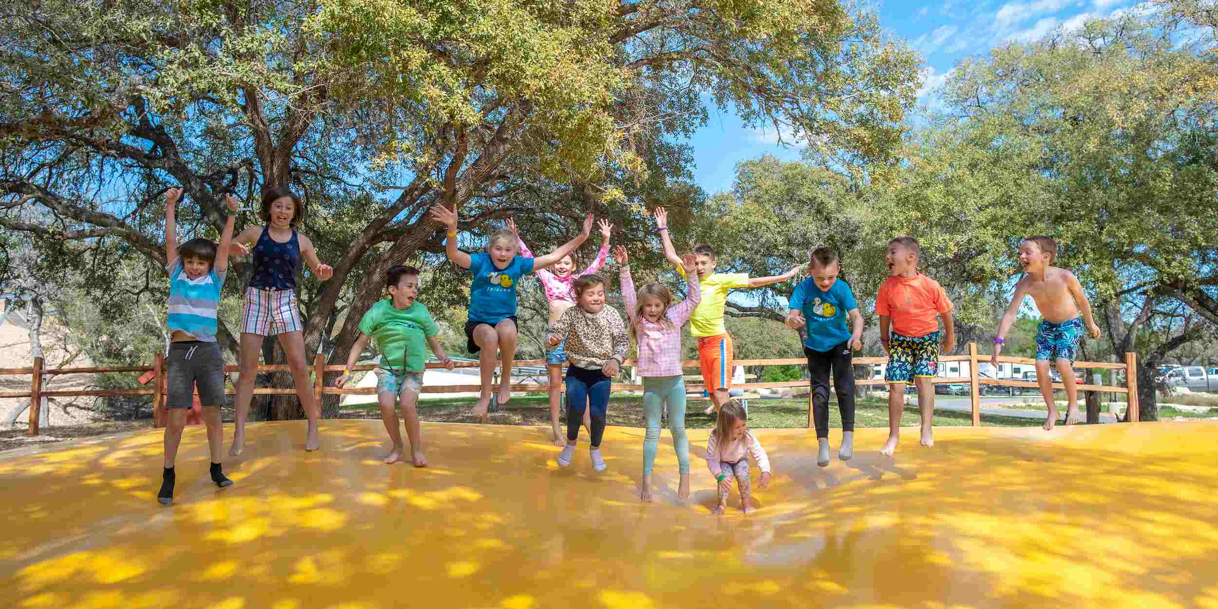 Kids jumping on the jumping pillow at Camp Fimfo