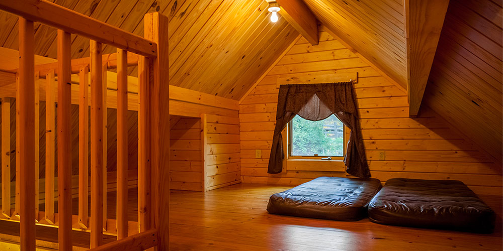 Enjoy a private loft while glamping in Ohio in a Deluxe Lakeside Lodge.