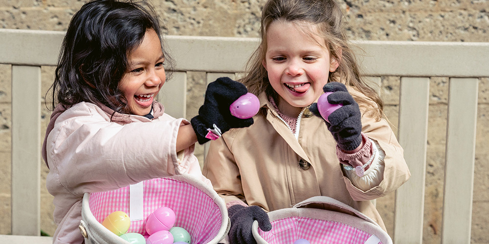 Kids celebrating Easter with plastic eggs at the Easter Bunny Egg Hunts & Train Rides event.