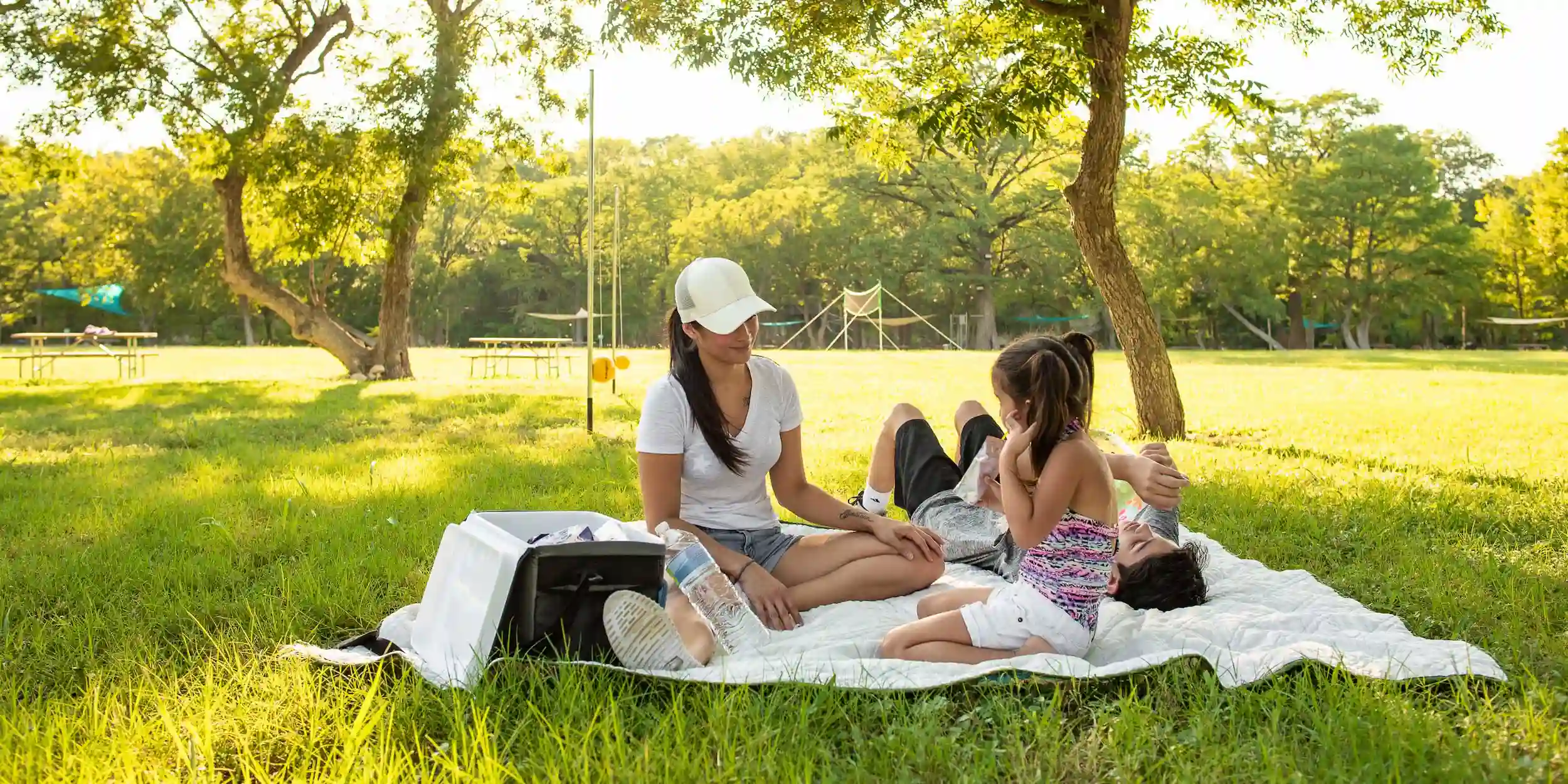 Guests having a picnic and relaxing outside in the spring at Camp Fifmo