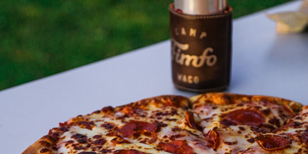 A pizza and beer from Squirrely's Tavern at Camp Fimfo Waco