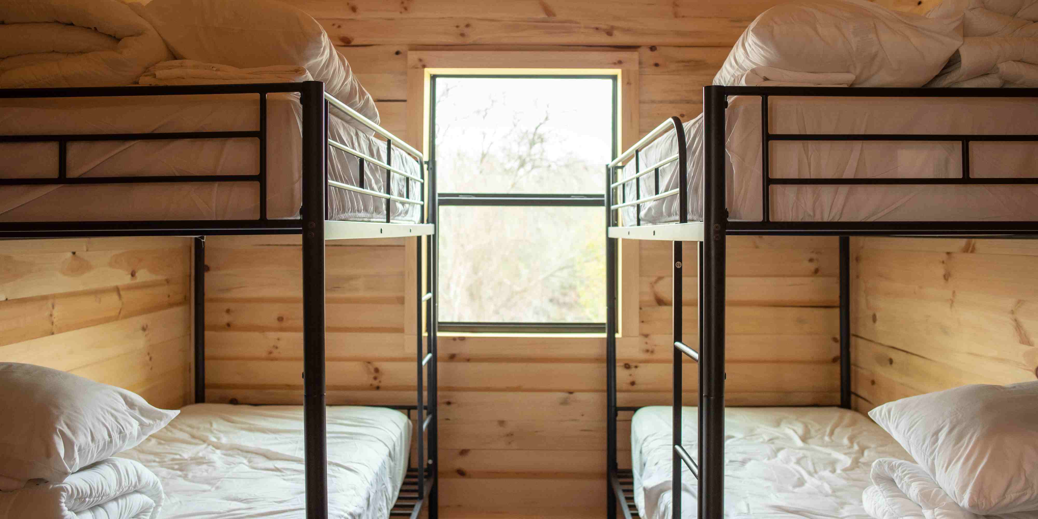 A look inside one of the bedrooms in a Mammoth Cabin with bunk beds at Camp Fimfo Waco