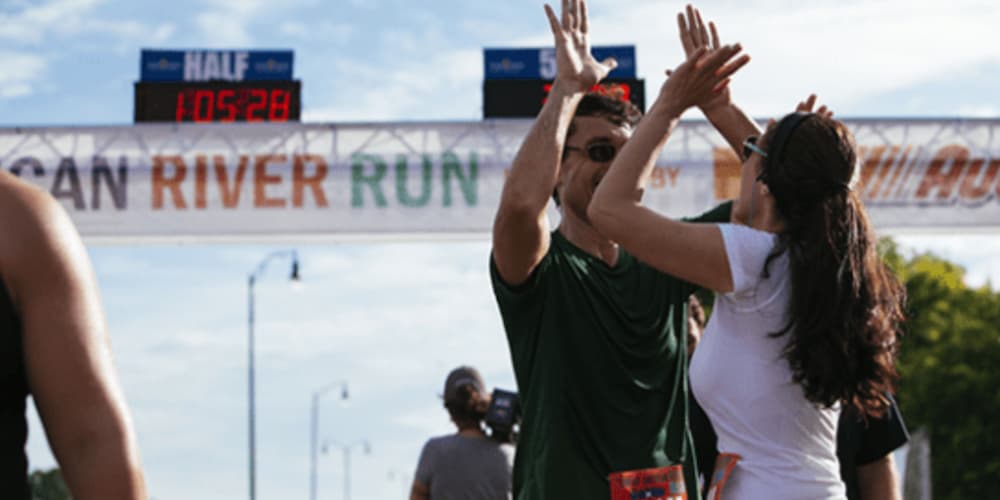 People high-fiving after the Great American River Run - a top Memphis event.