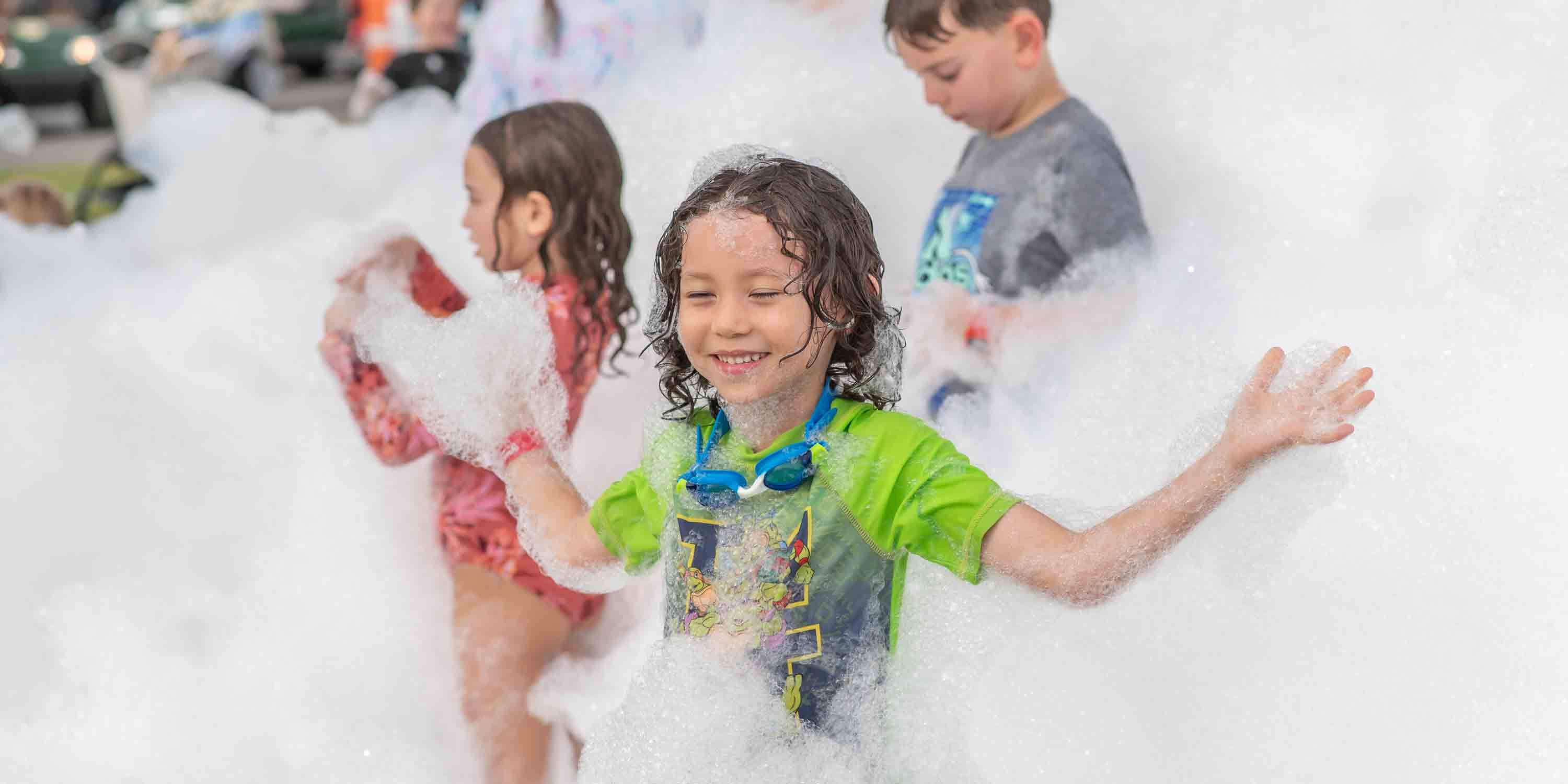 Guests enjoying the foam at a Camp Fimfo Waco foam party