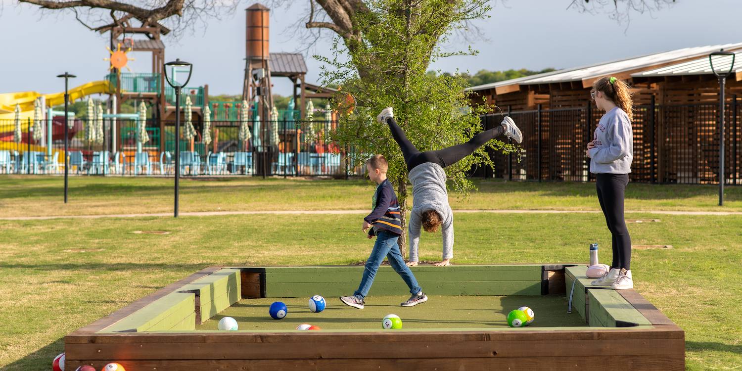 Guests playing yard games at Camp Fimfo Waco