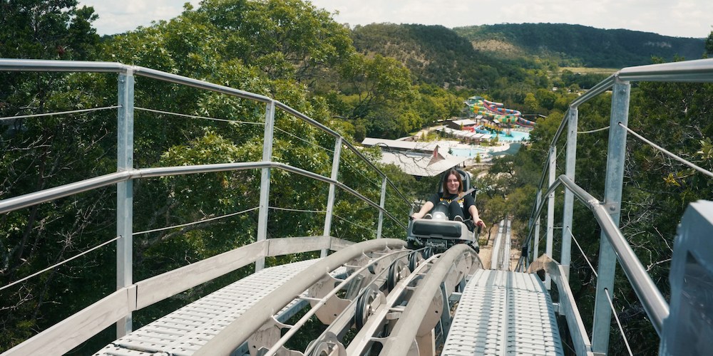 A sky-view of a rider on the Fimfo Adventures Cliff Carver at Camp Fimfo Texas Hill Country