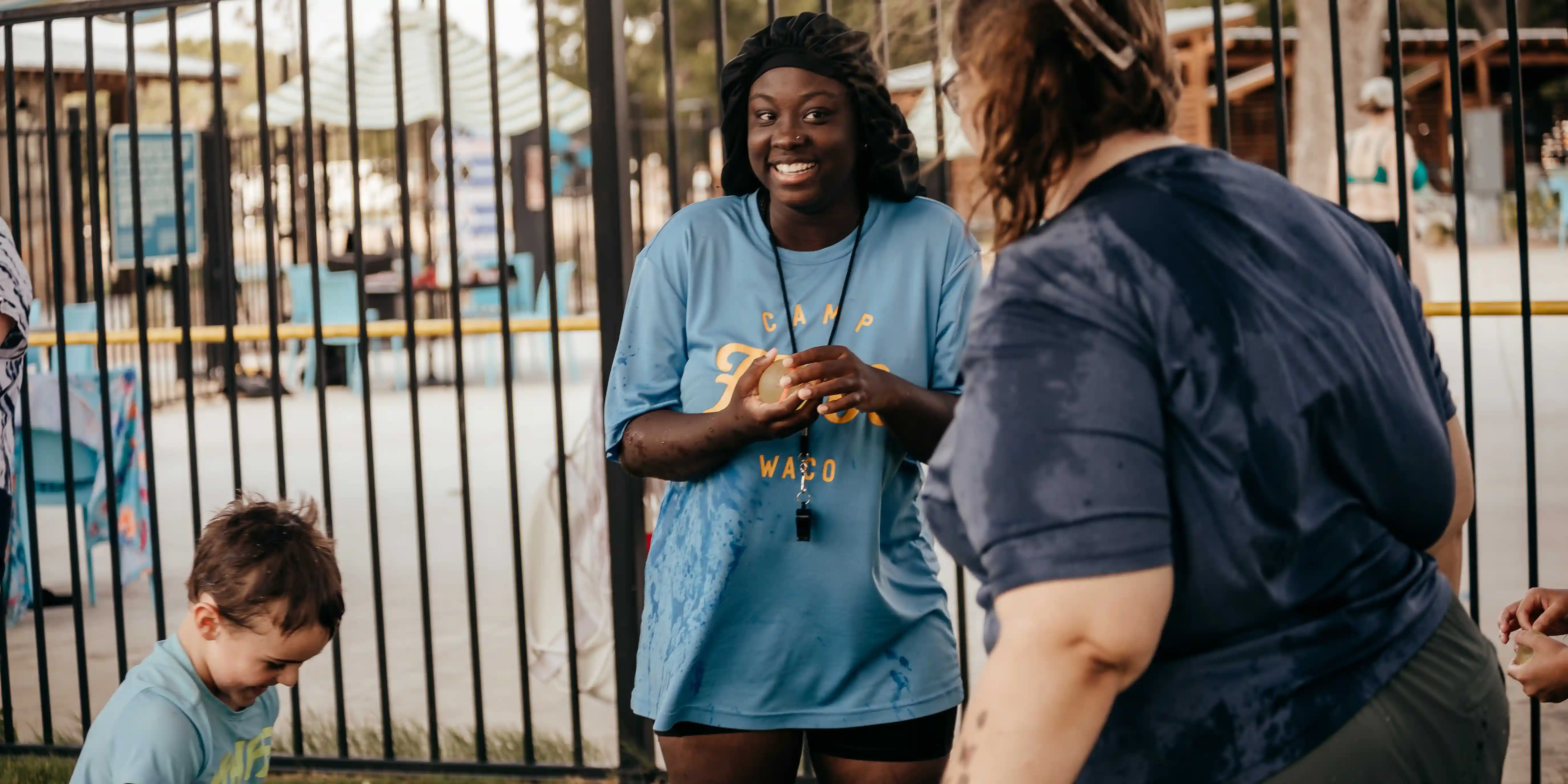 A smiling Camp Fimfo staff member