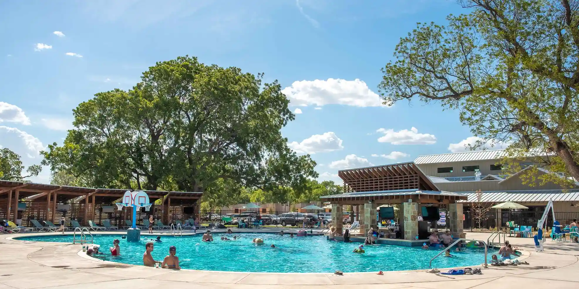Cool off after participating in the Ironman 70.3 Waco in the Camp Fimfo Waco pool and swim-up bar