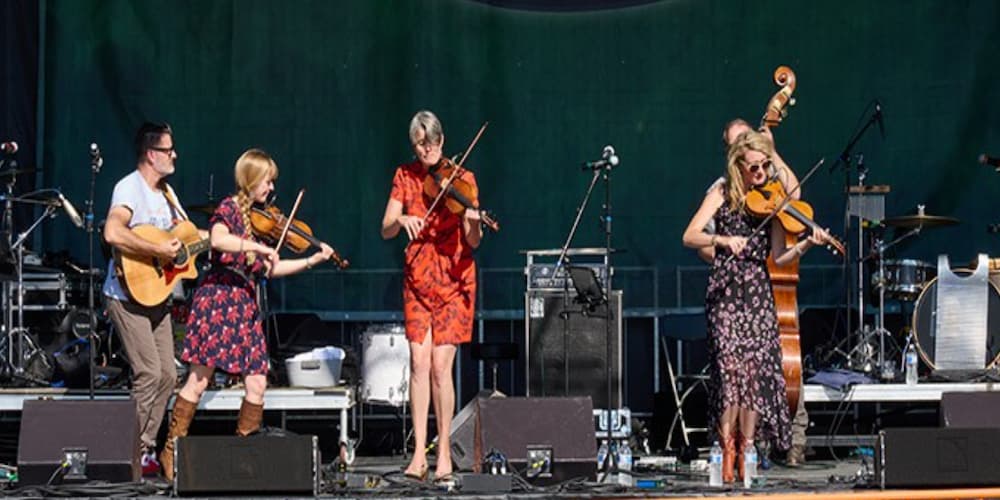 A group of musicians playing music on an outdoor stage, music festivals in downtown Pittsburgh, PA