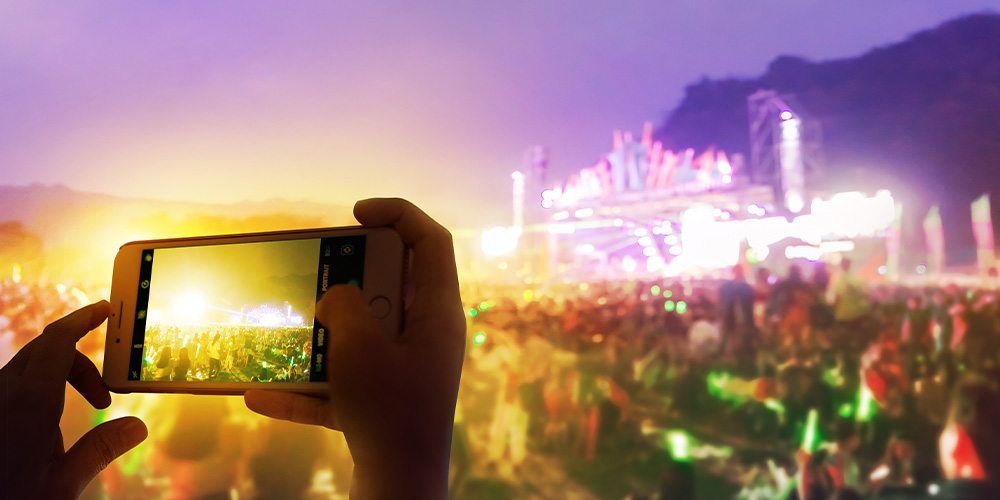 Person taking photo of the Reggae Fest in Cleveland, OH.