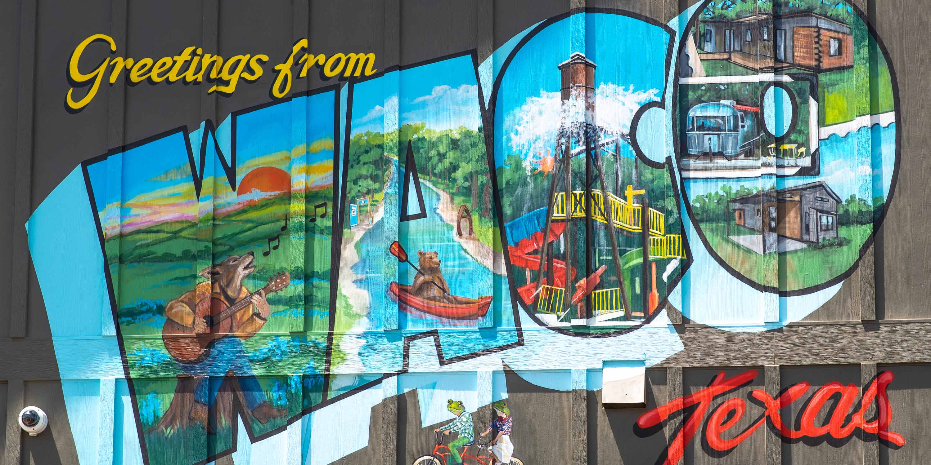 A mural at Camp Fimfo Waco that says, "Greetings from Waco, Texas"
