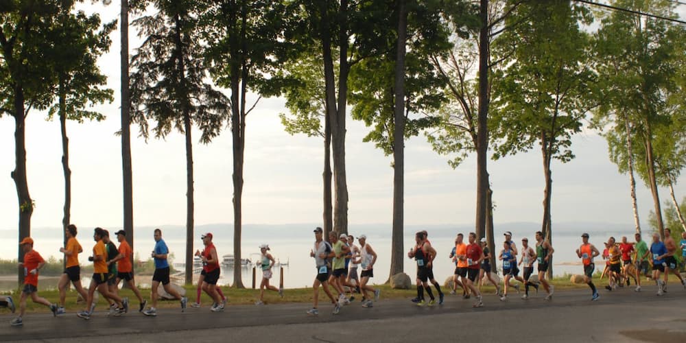 A group of people running for the Bayshore Marathon in Traverse City.