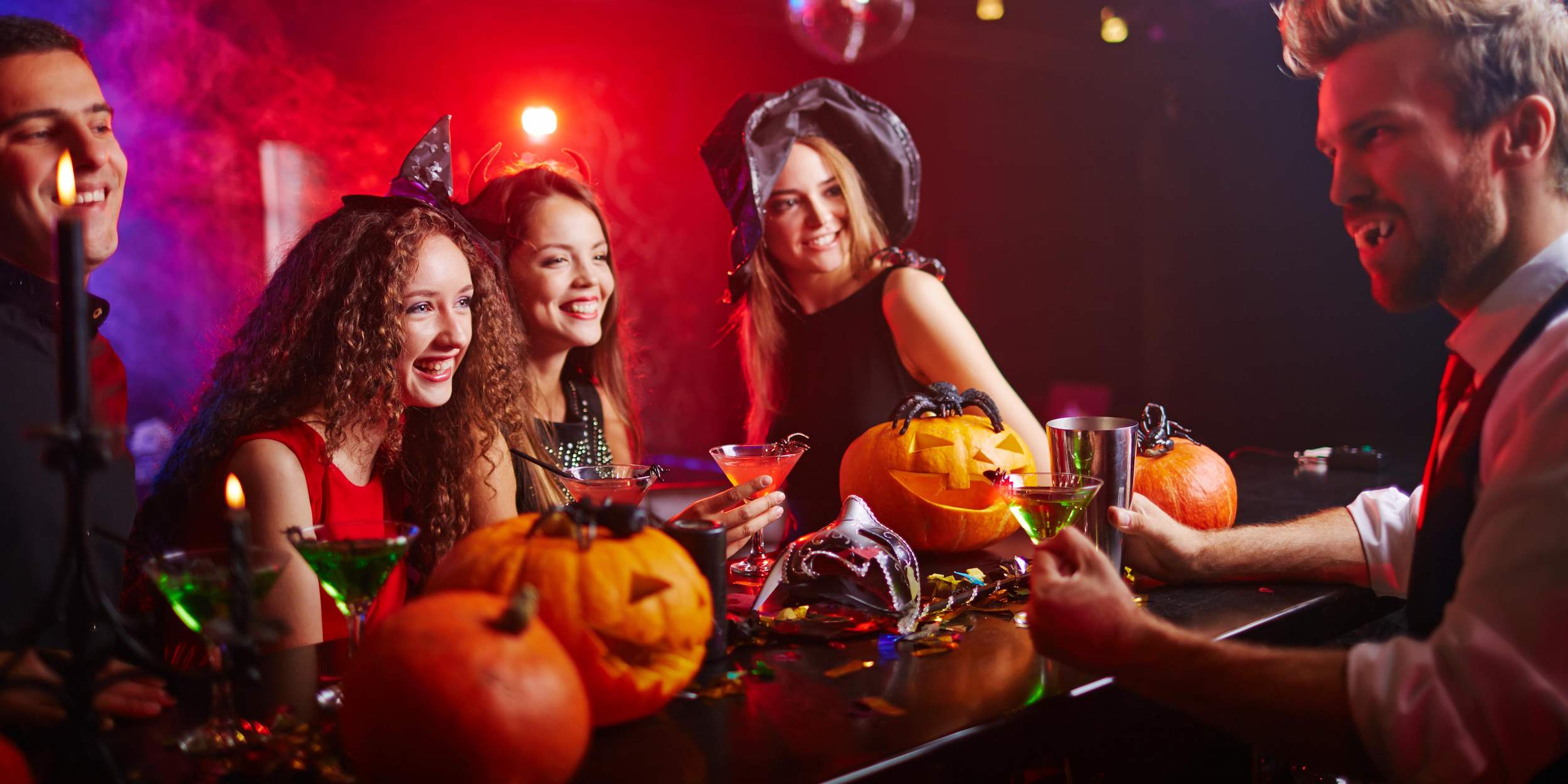 Guests dressed in Halloween costumes at a Halloween-themed bar