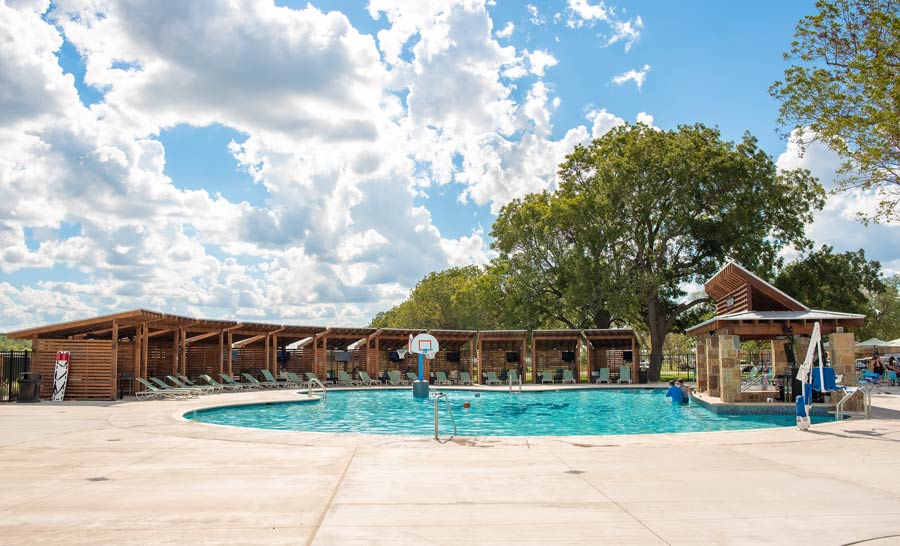 Resort-style pool and swim-up bar at Camp Fimfo Waco