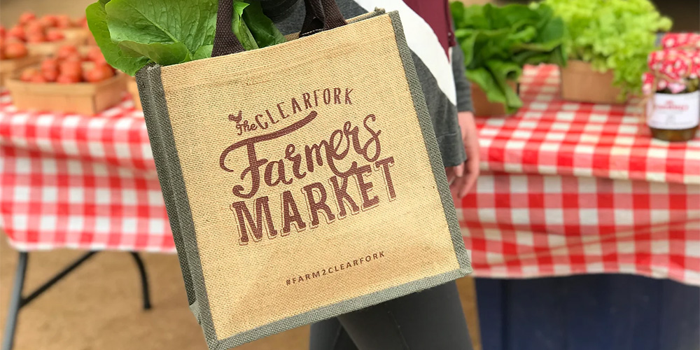 Someone shopping at Clearfork Farmers Market in Fort Worth for local produce.