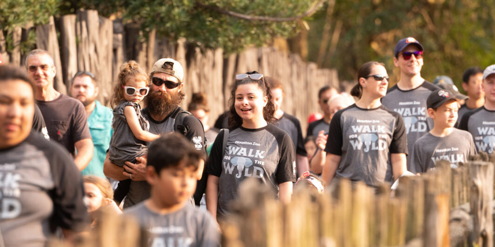 A group of people walking during the Houston Zoo's Walk of the Wild to save wildlife.