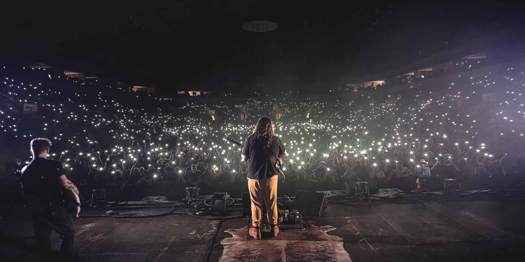 Kolby Cooper performing on-stage at a concert