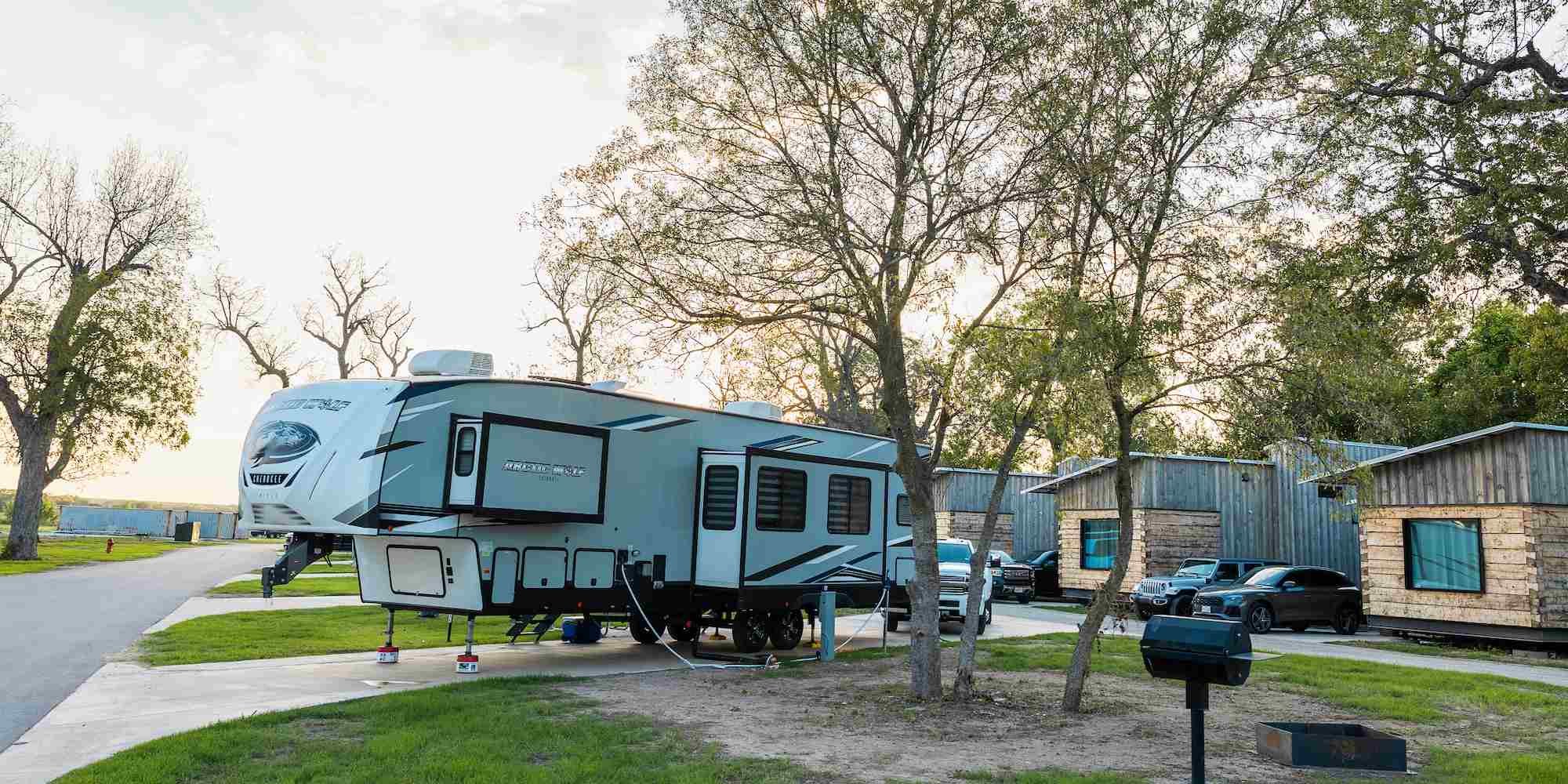 An RV site and cabins at Camp Fimfo Waco