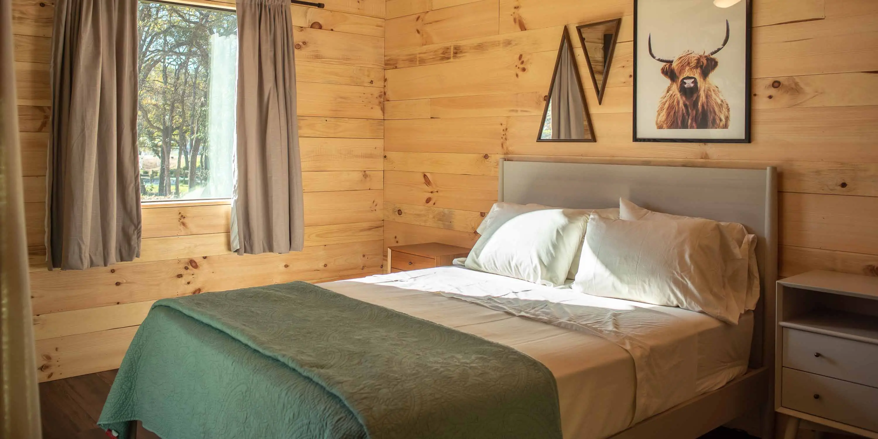 A private bedroom inside a Coyote Cabin at Camp Fimfo