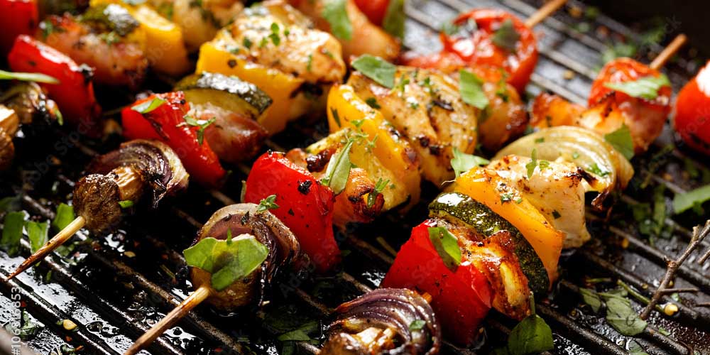 Chicken and veggie kabobs over an open grill