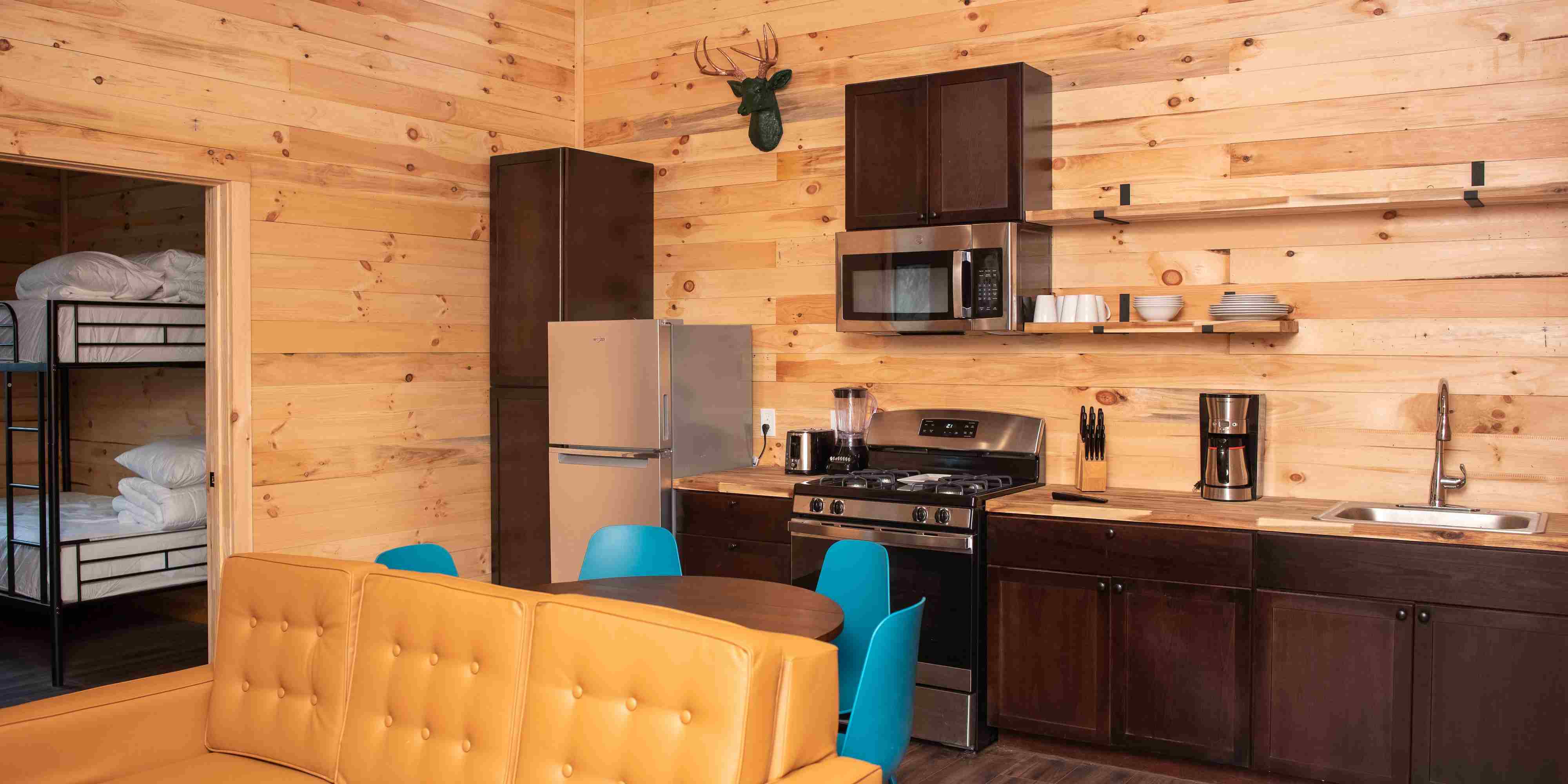 The full kitchen inside a Mammoth Cabin at Camp Fimfo Waco