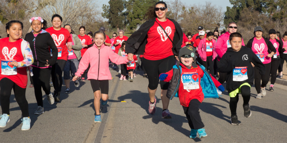 Children and adults running during the Valentine Run/Walk Sacramento event that helps raise awareness for justice.