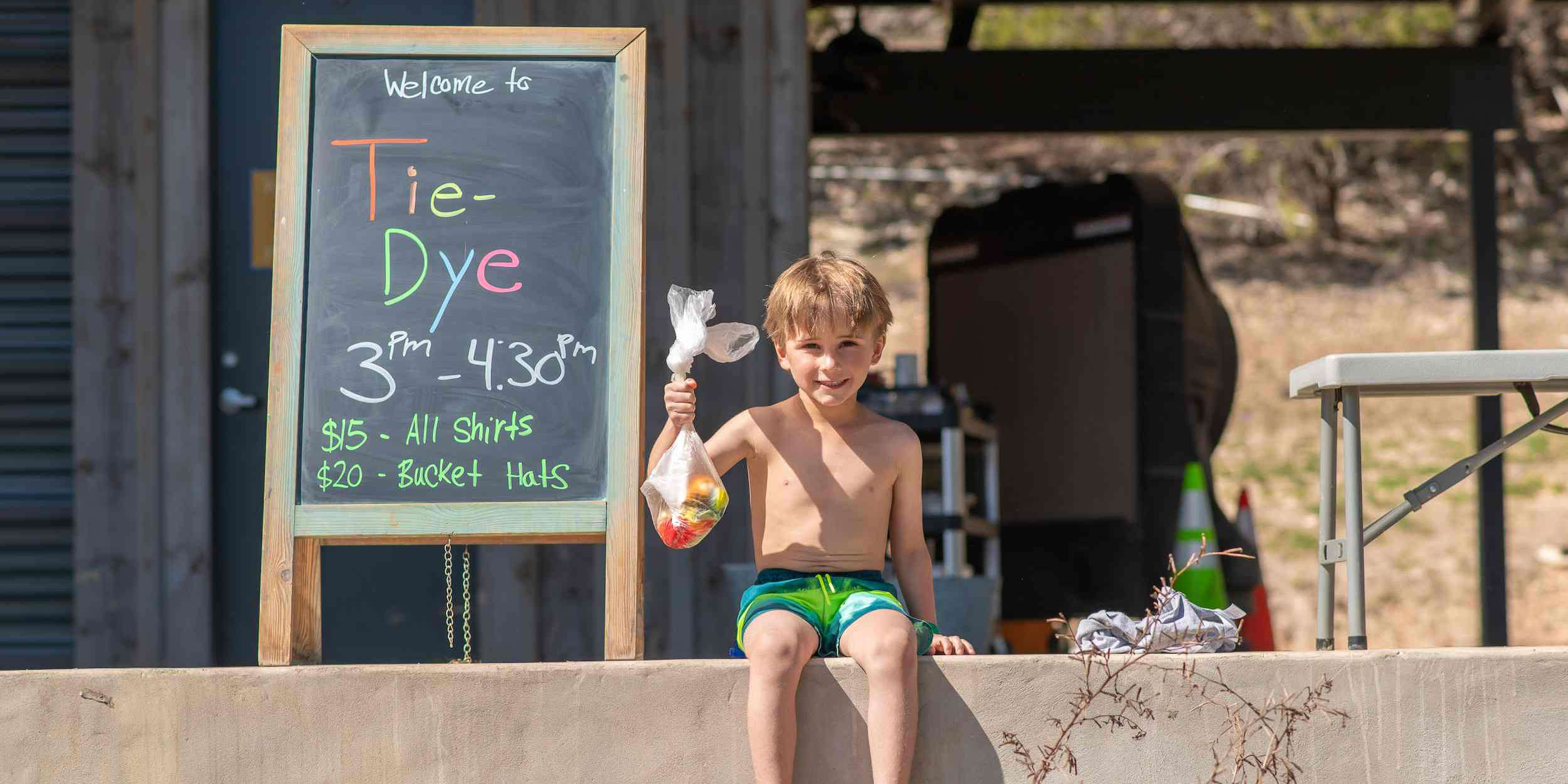 A child holding his tie-dye creation at Camp Fimfo Texas Hill Country