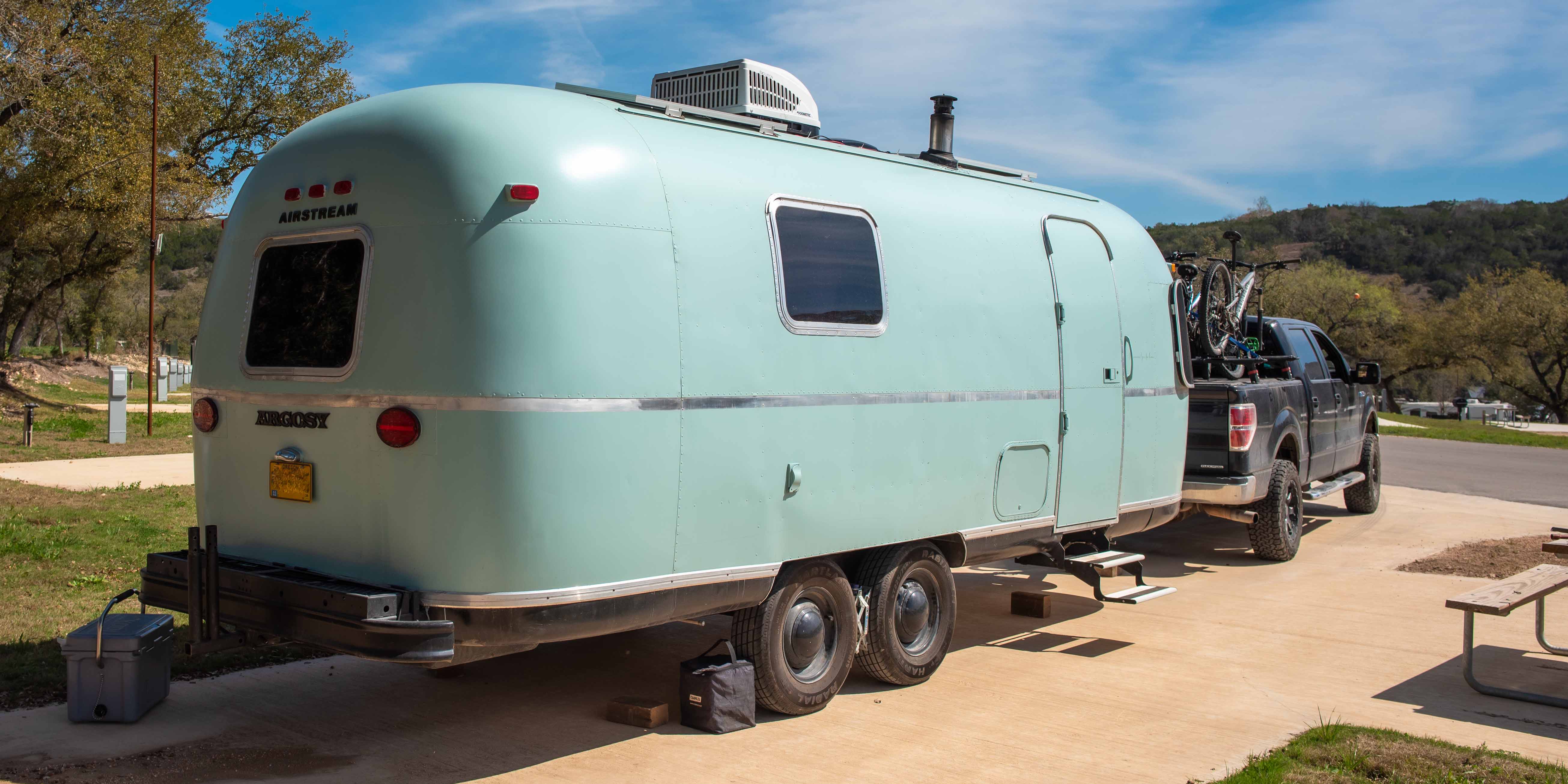 A vintage trailer in an RV site at Camp Fimfo