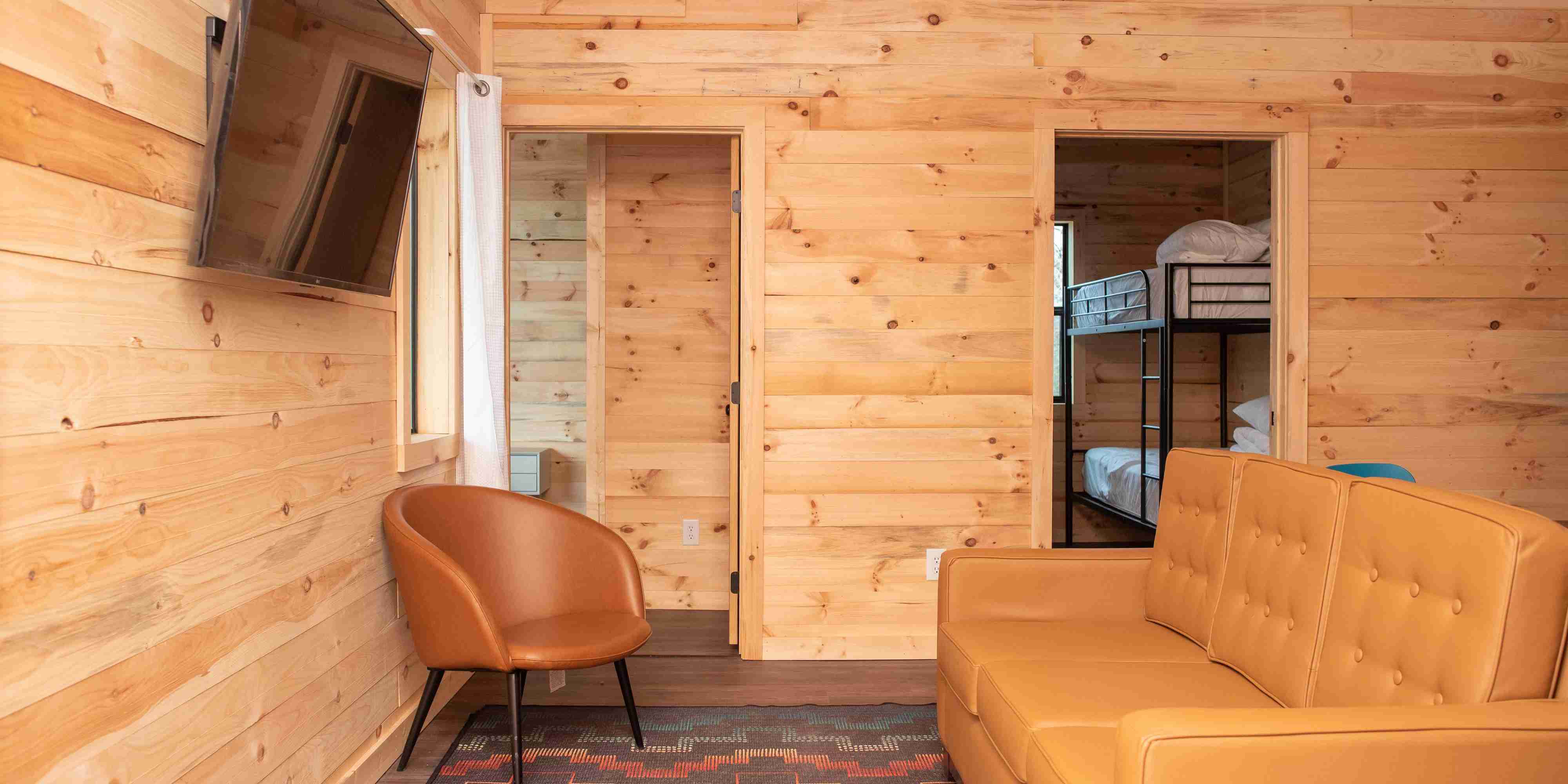 The living room area of a Mammoth Cabin at Camp Fimfo Waco