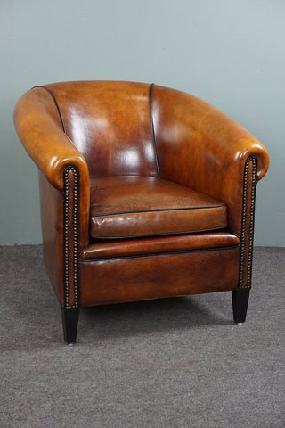 Sheep leather club chair with decorative nails