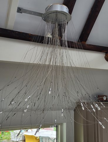 Modern chandelier consisting of 42 adjustable wires with lights. Designer unknown.