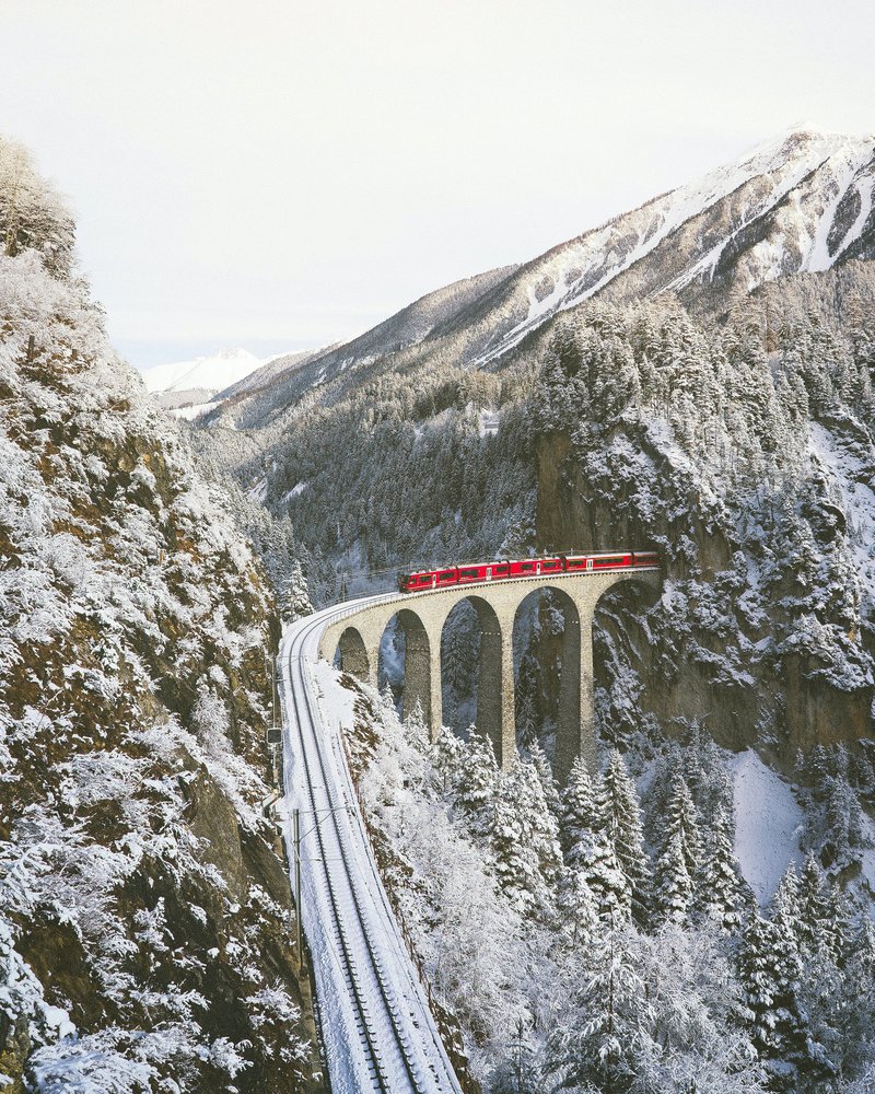 Commuting by train in the snowy mountains.