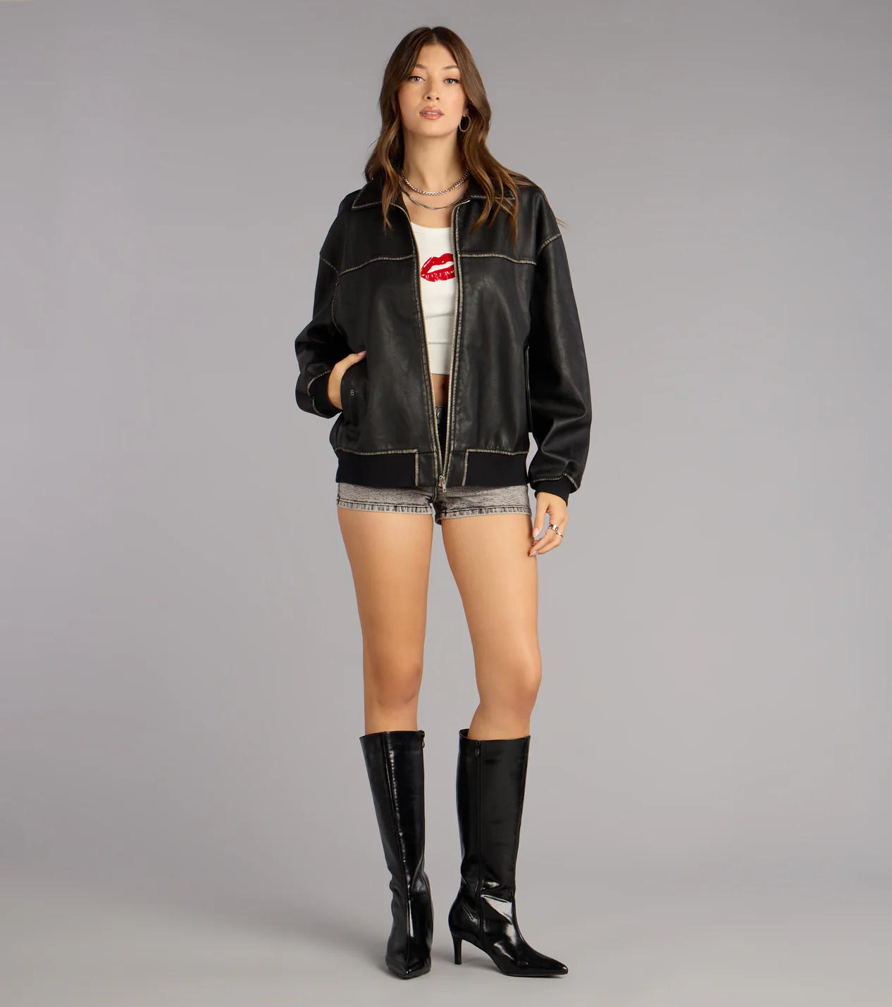 Black Faux Leather Oversized Bomber Jacket with acid wash jean shorts and tall boots