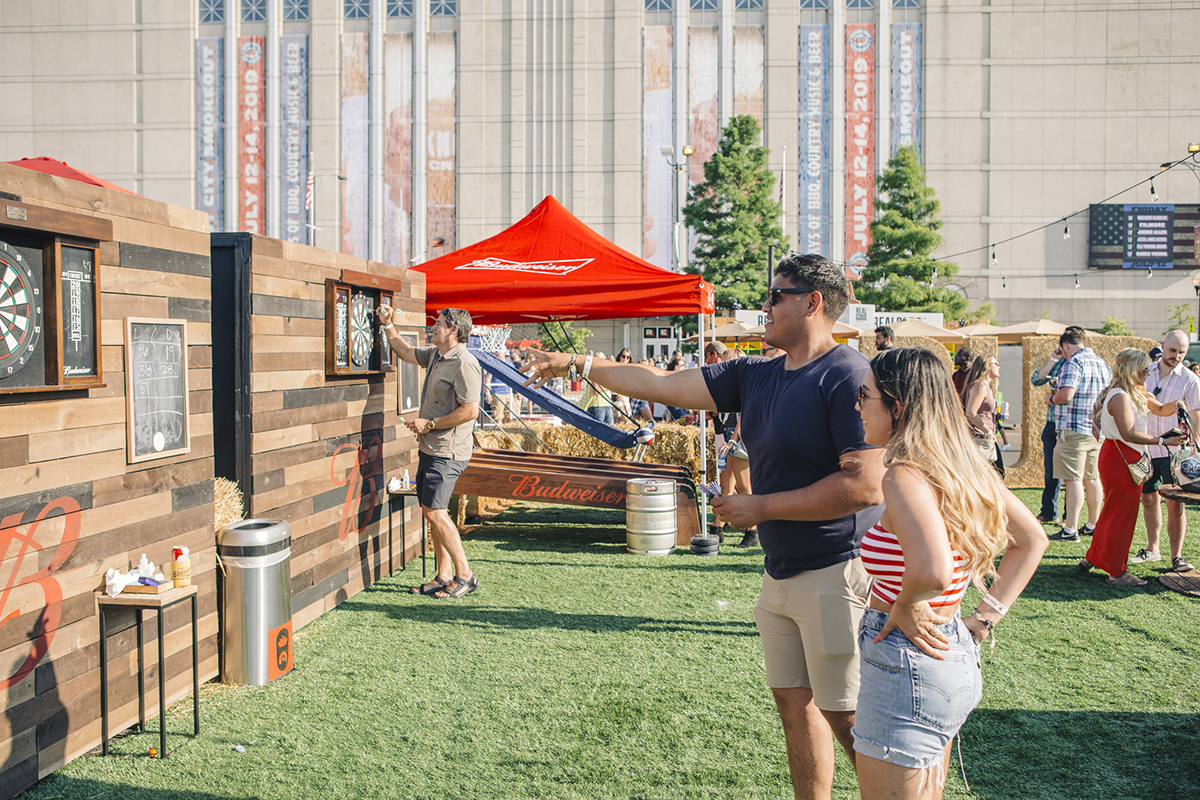 guests playing darts at the budweiser gaming area