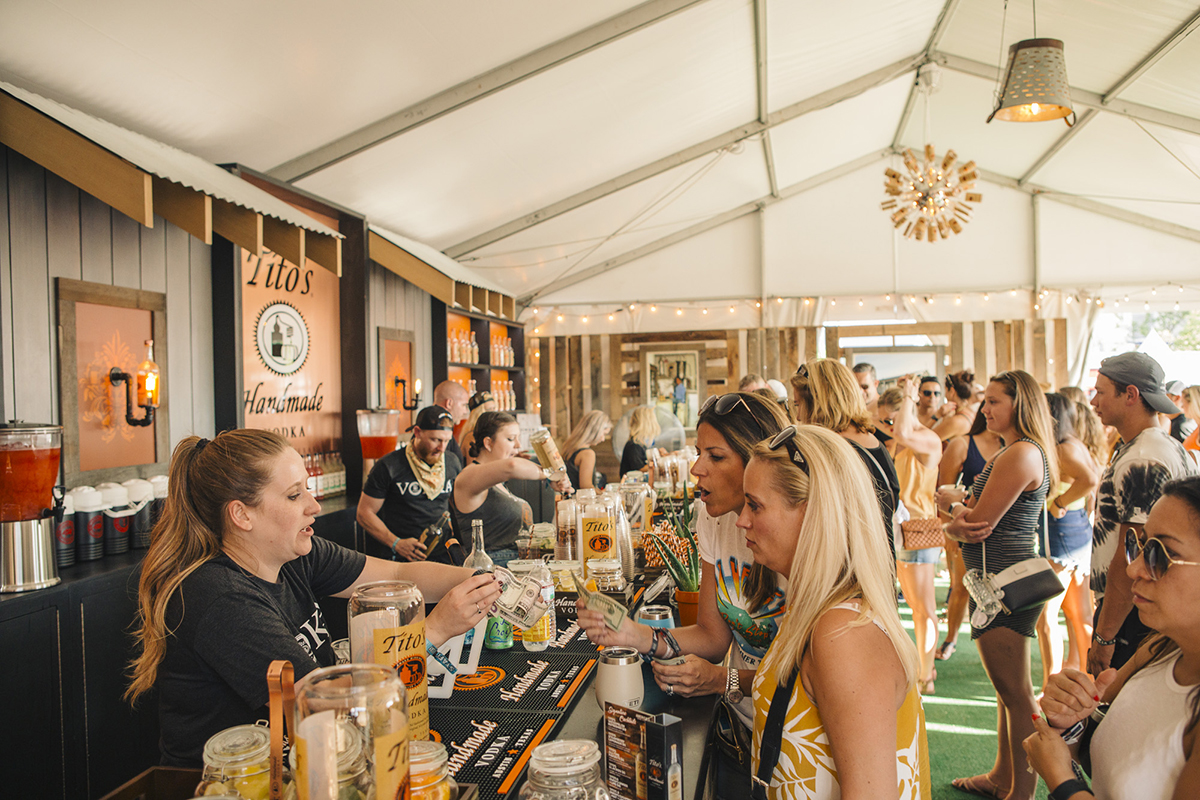 titos beverage tent with guests ordering drinks from the bar