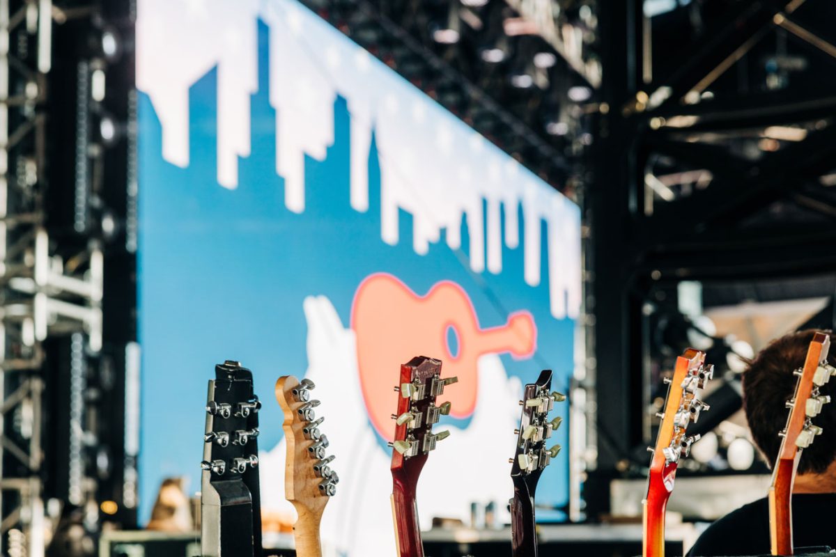 Array of guitars with Windy City SmokeOut stage in the background