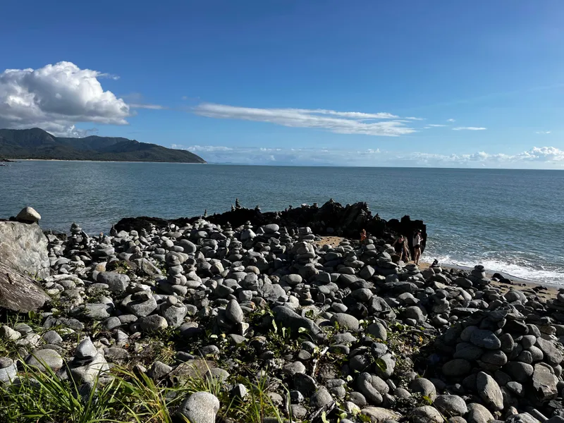 The rocky point covered in stone stacks, with blue sea behind