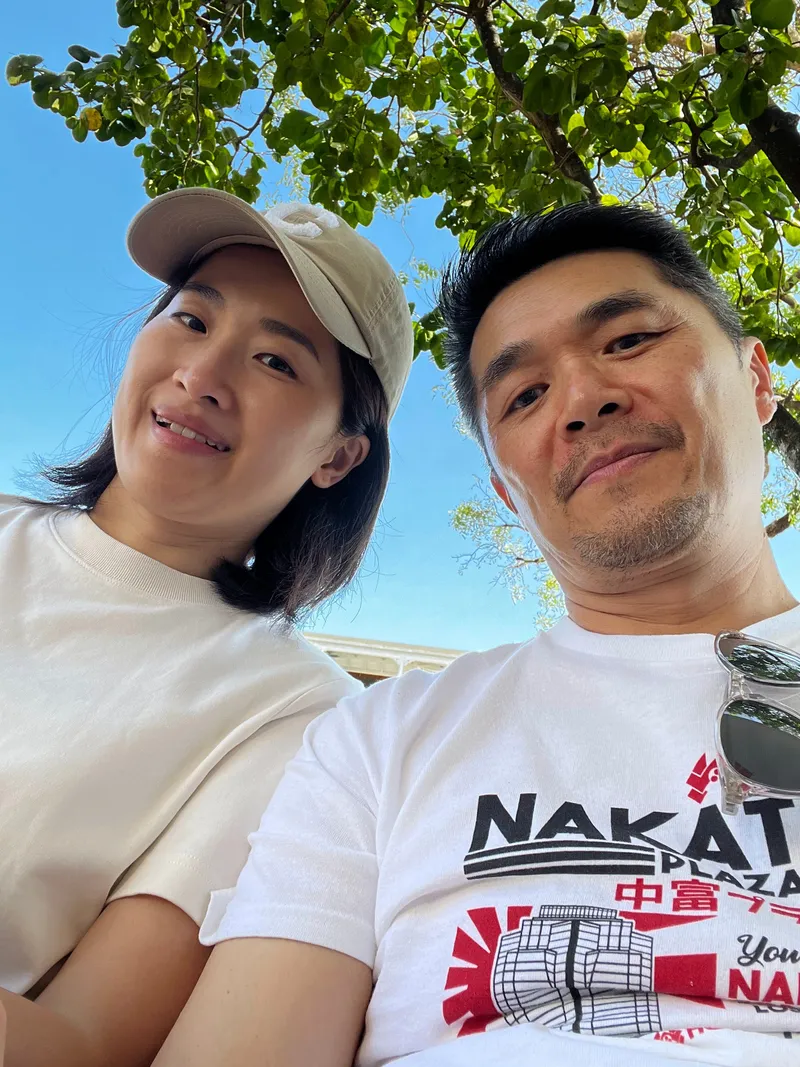 A selfie of two people in the shade on Four Mile Beach