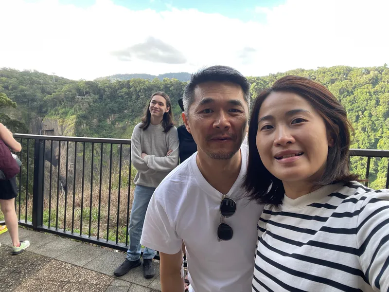 A selfie of two people at the Barron Falls stop, with a teenager behind