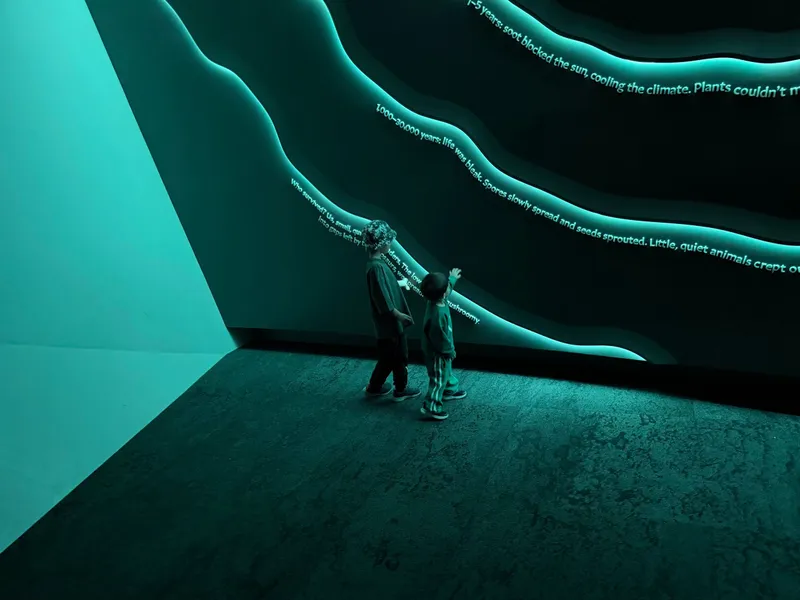 The boys reading the glowing wavy lines on the wall