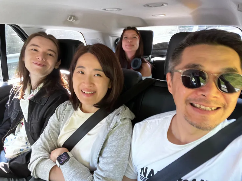 A selfie of four people in the car