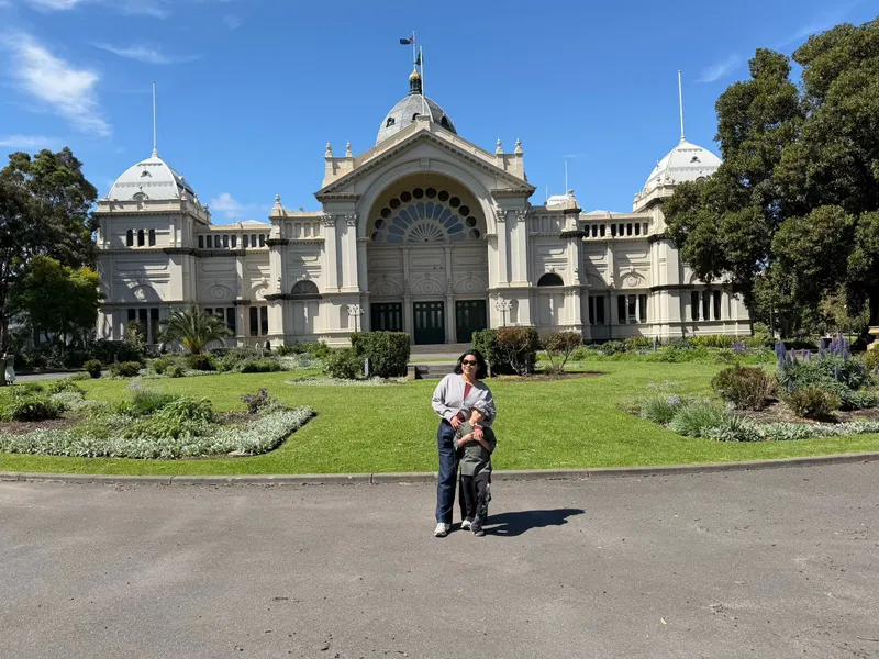 Standing in front of the Royal Exhibition Building in Carlton Gardens on a sunny day