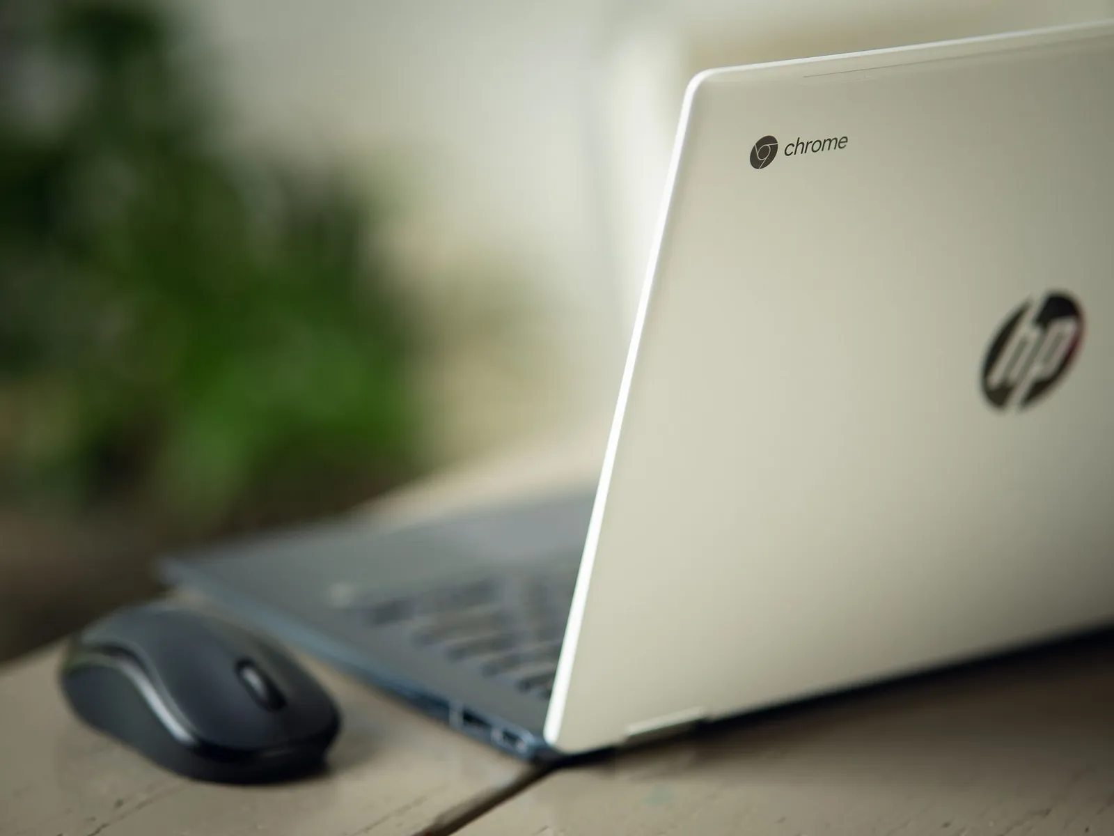 An HP Chromebook and a mouse on a desk
