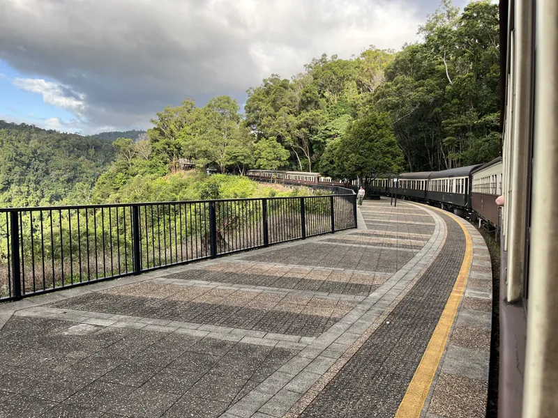 The curving platform and the long train at the Barron Falls stop