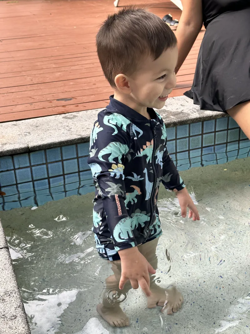 The toddler splashing in the shallows