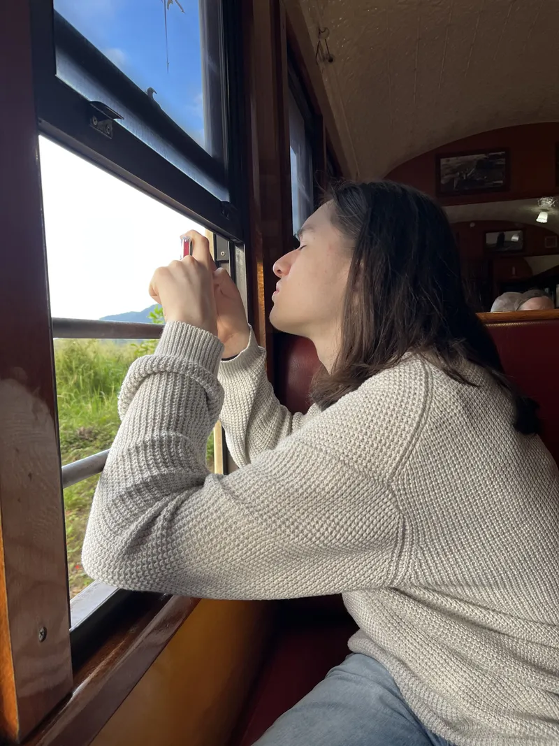 A teenager leaning out of the window to look down the line